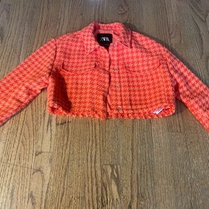 Cropped orange jacket.